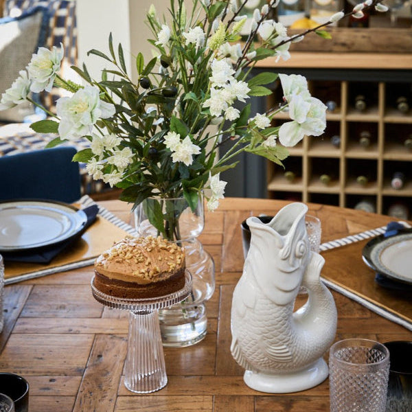 Kitchen scene with small ckae stand and gluggle jugs