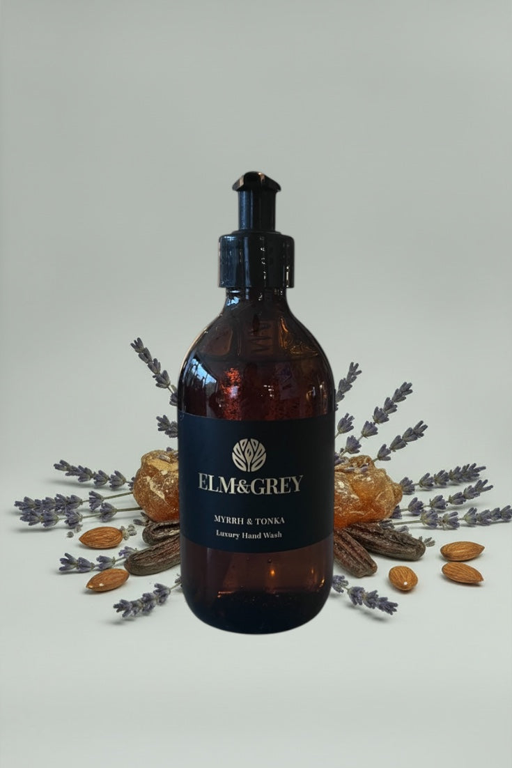 Myrrh and Tonka fragranced Amber bottle with pump dispenser labeled 'Elm&Grey' on a white background fragrance is lavender, tonka beans and amber