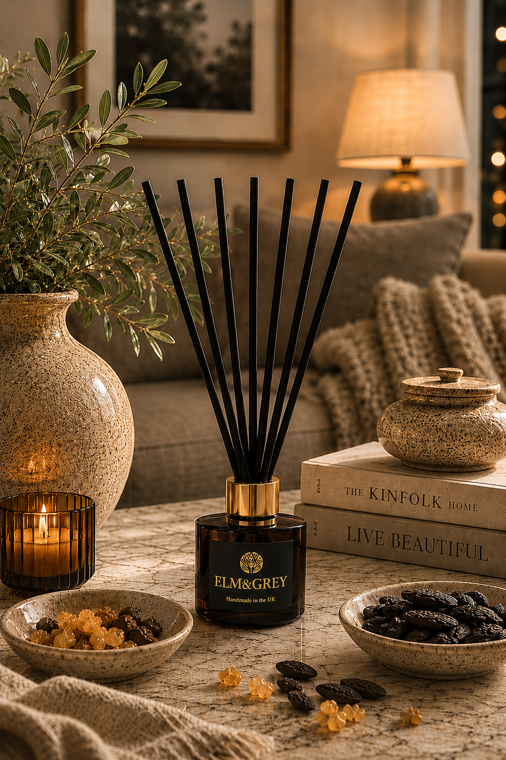 Elm & Grey Myrrh & Tonka reed diffuser in a cosy living room with warm ambient lighting and luxury home styling