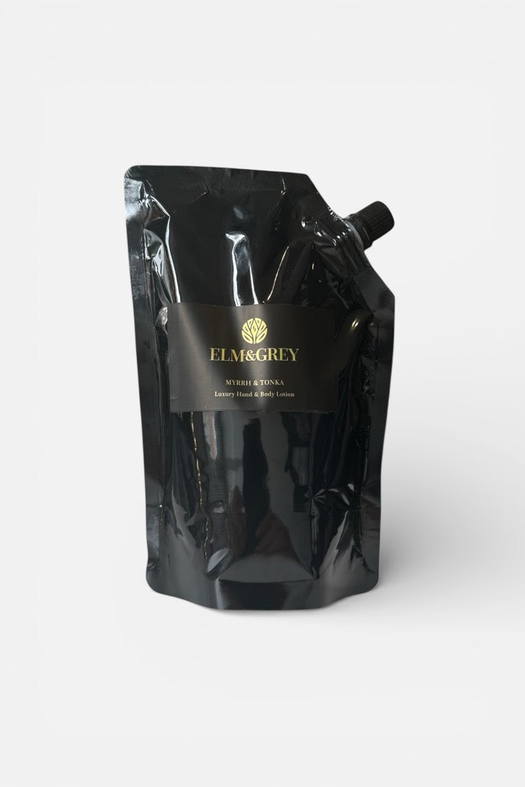 Black refill pouch for hand lotion with ELM and GREY branding on a white background