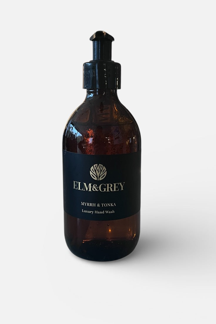 Myrrh and Tonka fragranced Hand wash in an Amber bottle with pump dispenser labeled 'Elm&Grey' on a white background