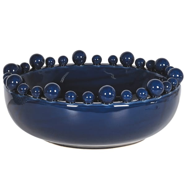 Blue ceramic bowl with spherical protrusions on a white background