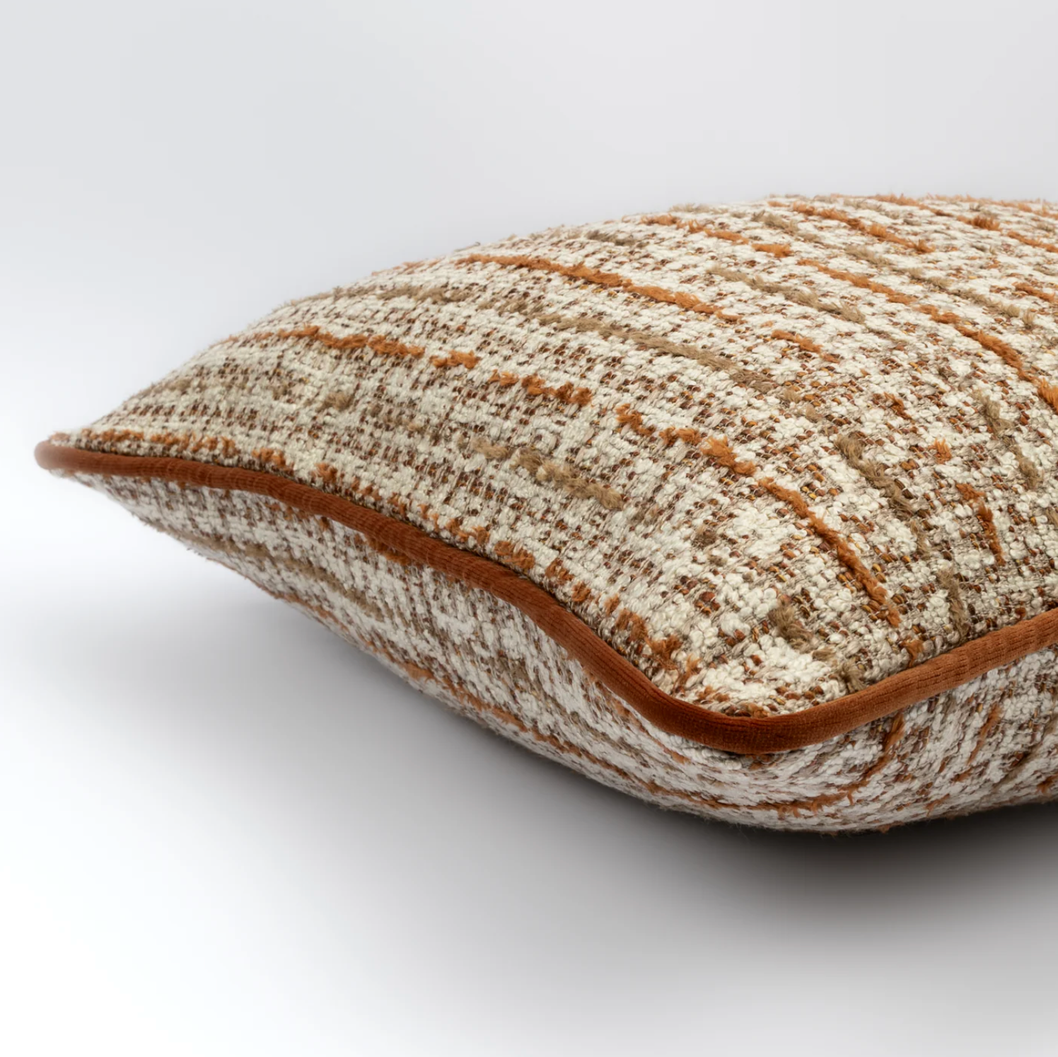 Textured cushion with brown and beige pattern on a white background