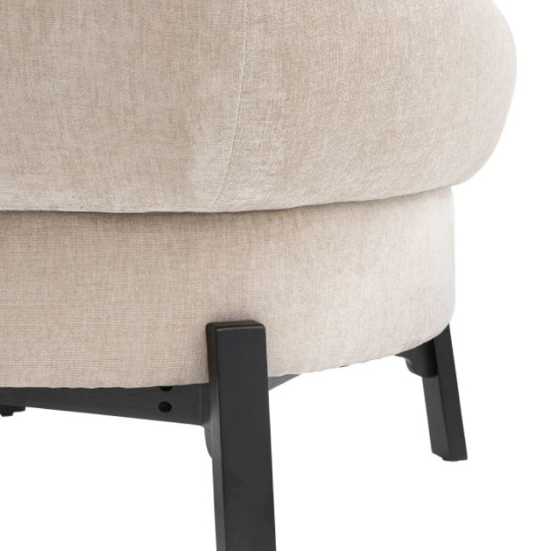 Close-up of a beige upholstered chair with black metal legs on a white background, Elm & Grey.