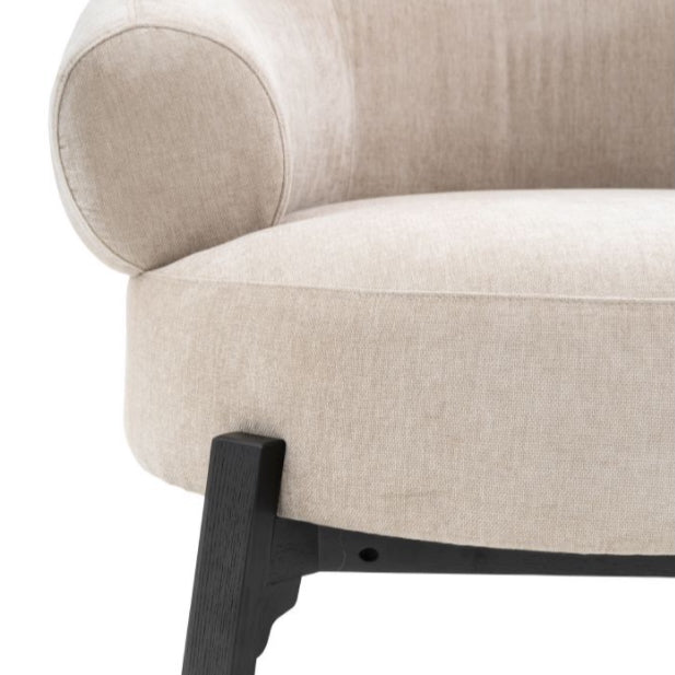 Beige armchair with black legs on a white background, Elm & Grey.