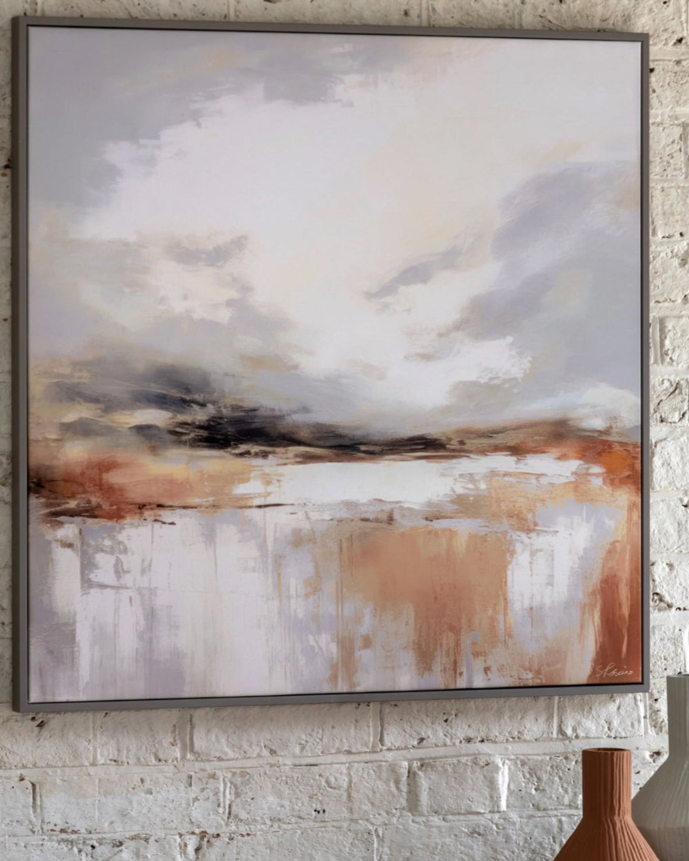 Abstract painting with earthy tones on a brick wall