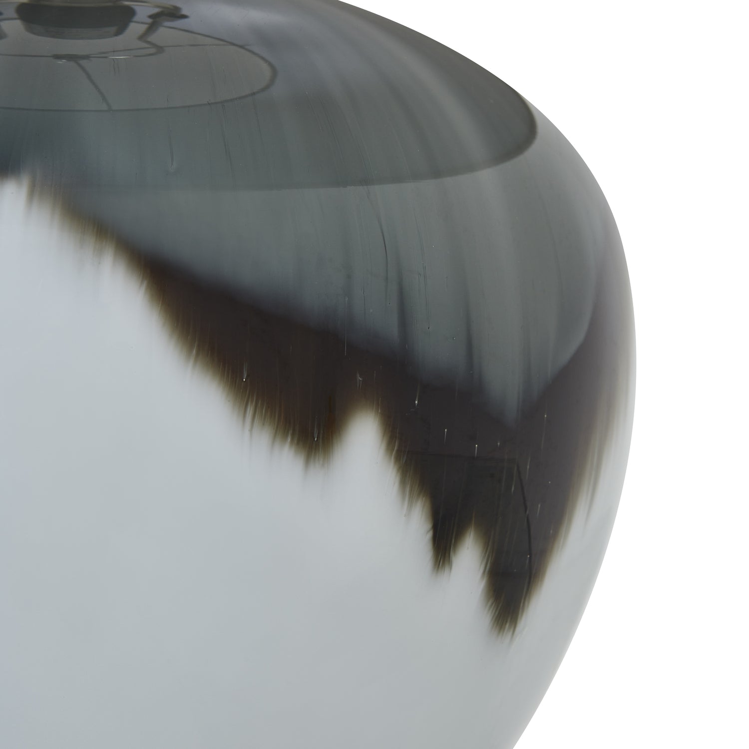 Close up of table lamp with a gray and white marbled base and beige lampshade on a white background