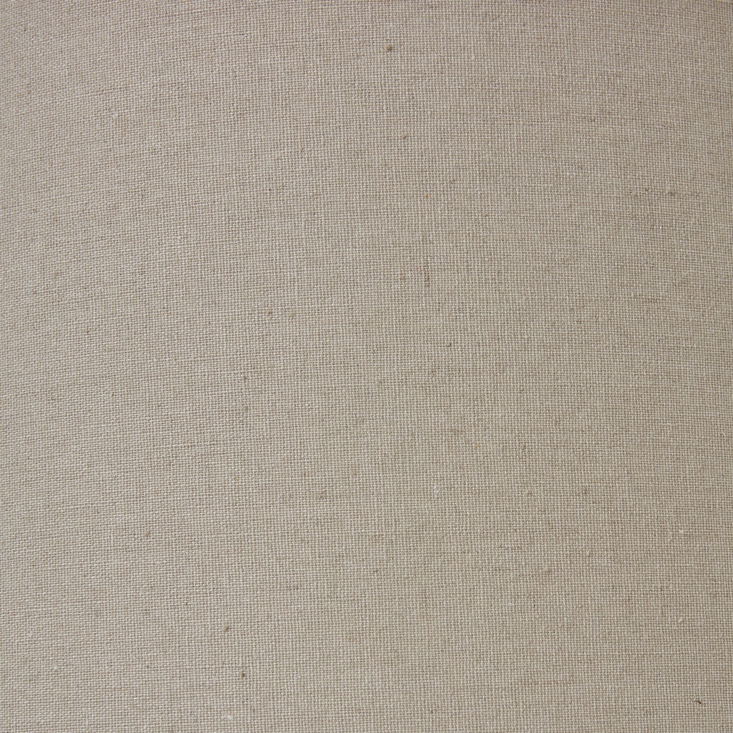 Close up of table lamp with a gray and white marbled base and beige lampshade on a white background