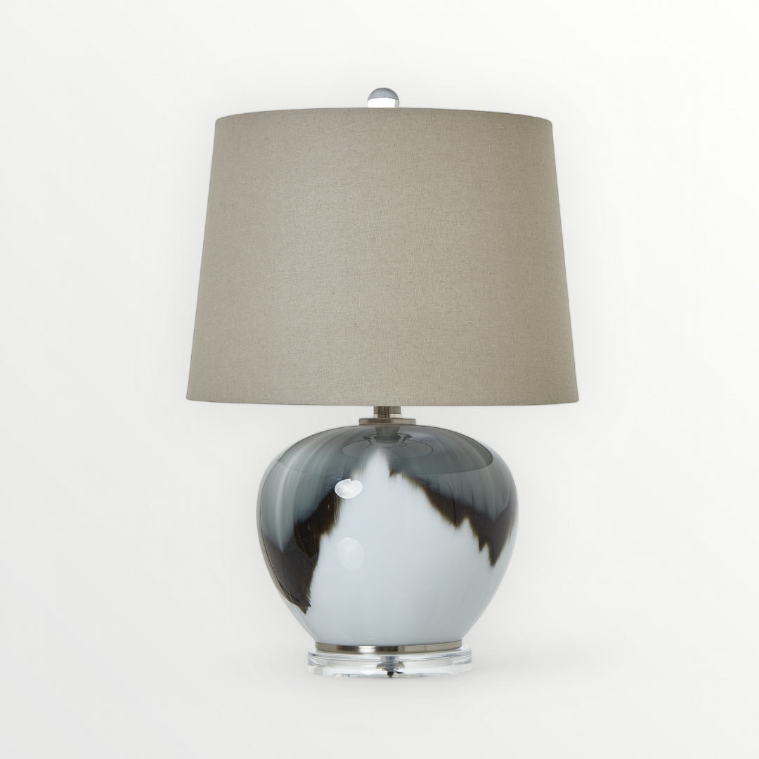 Table lamp with marbled design base and beige lampshade on a white background, Elm & Grey.
