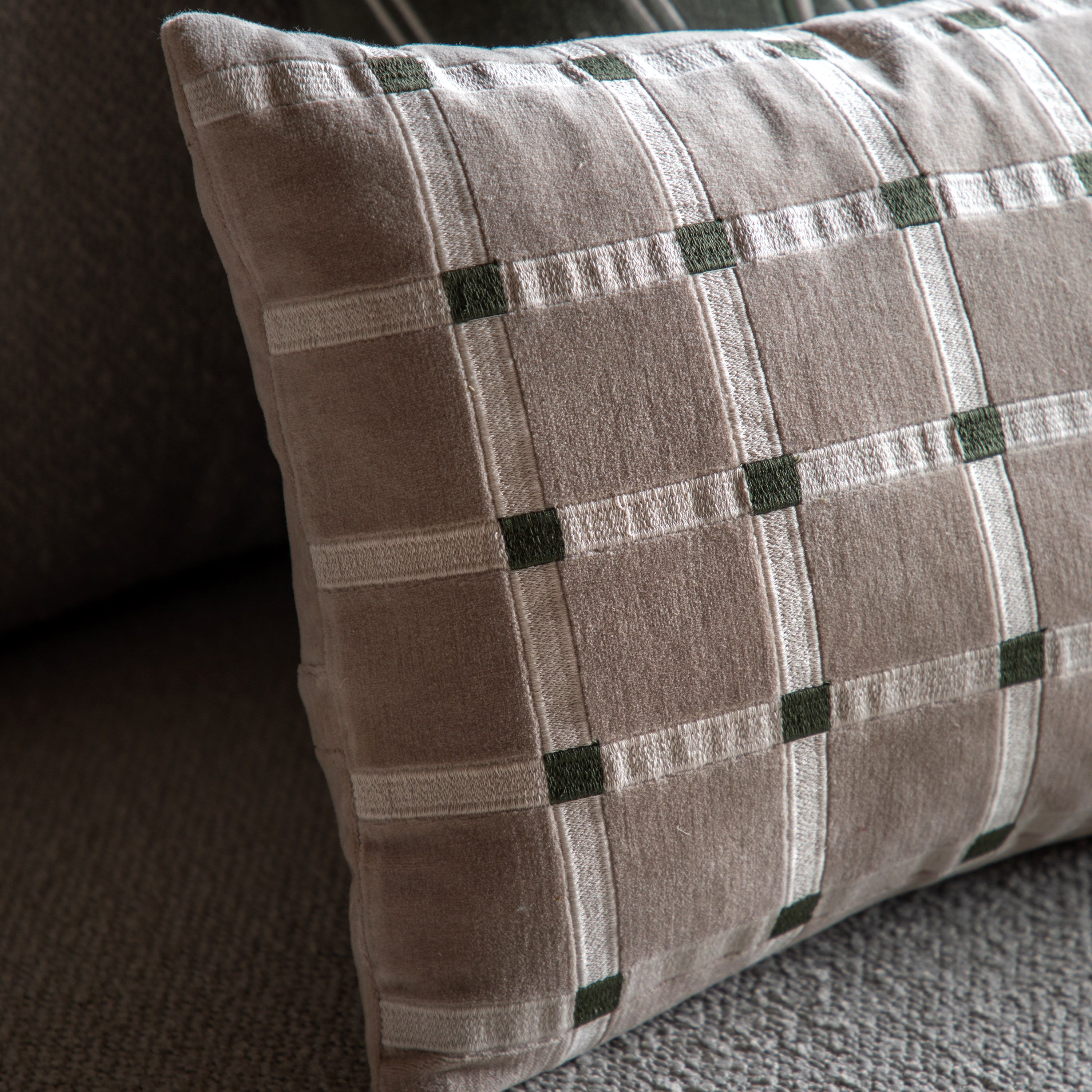 Plaid patterned pillow on a textured surface
