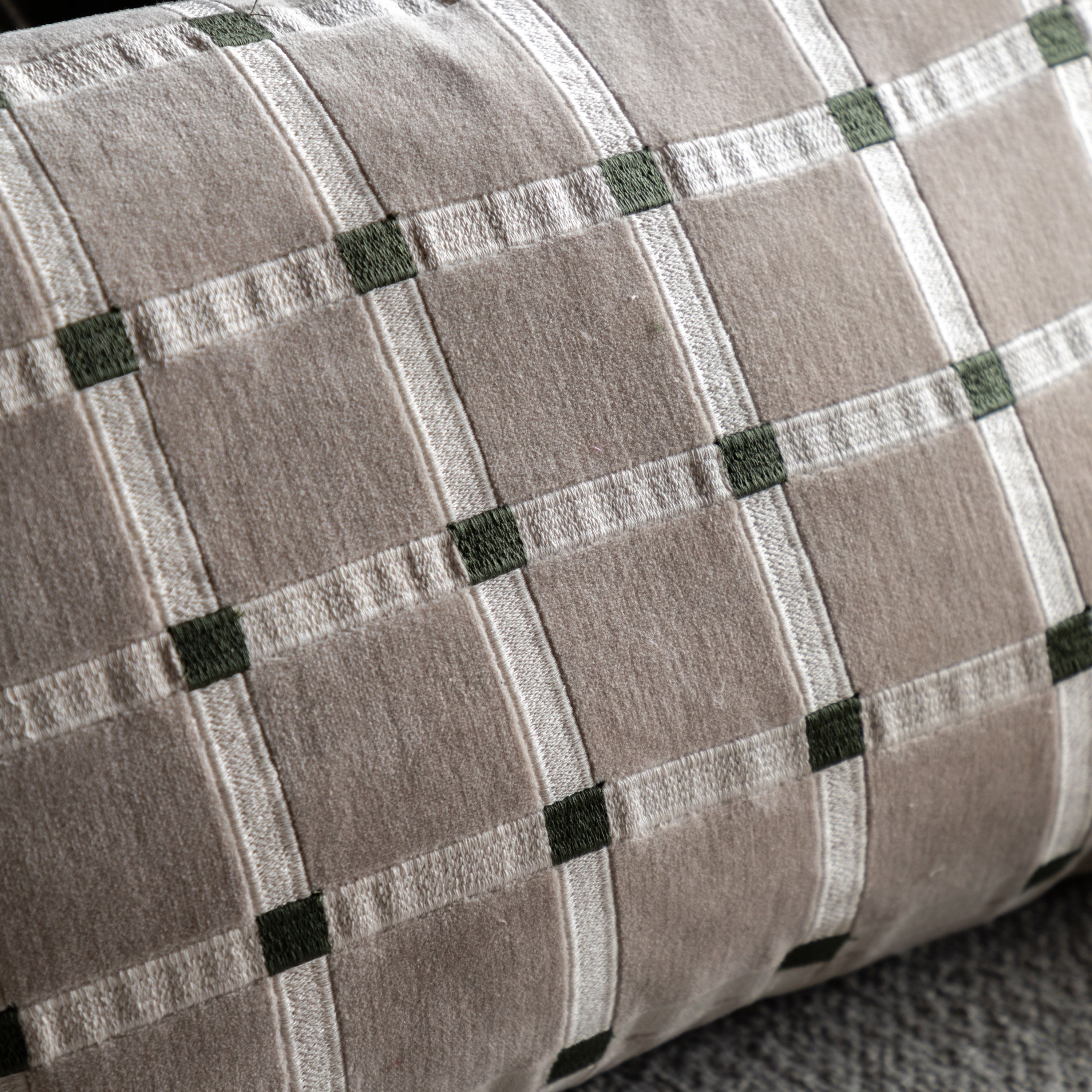 Close-up of a textured fabric with a checkered pattern in shades of gray and green.