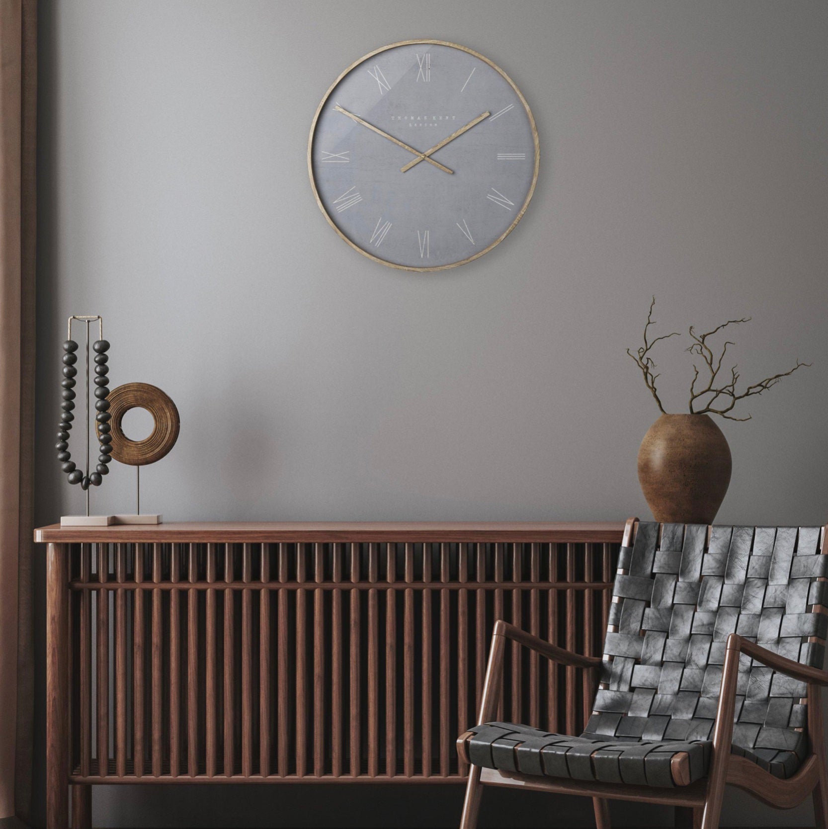Modern interior with a wall clock, decorative items, and a chair.