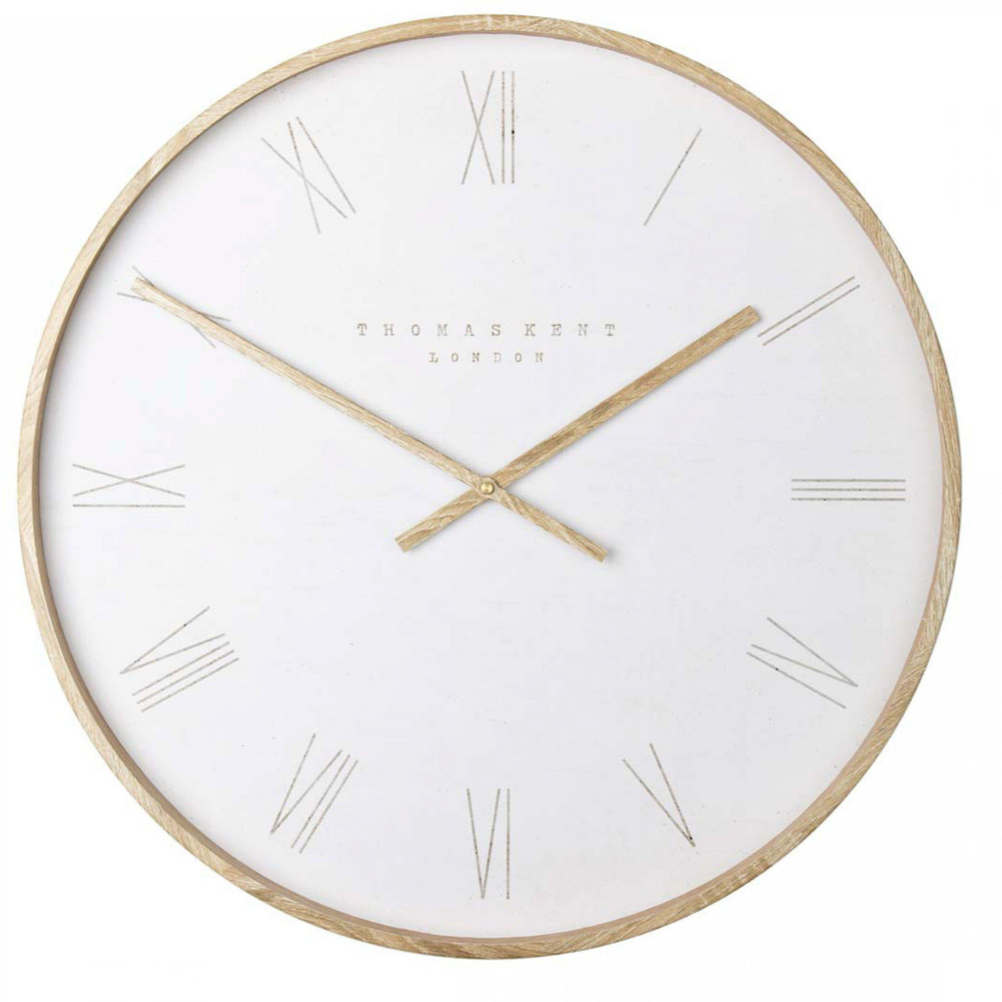 Round wall clock with gold hands and a white face on a white background