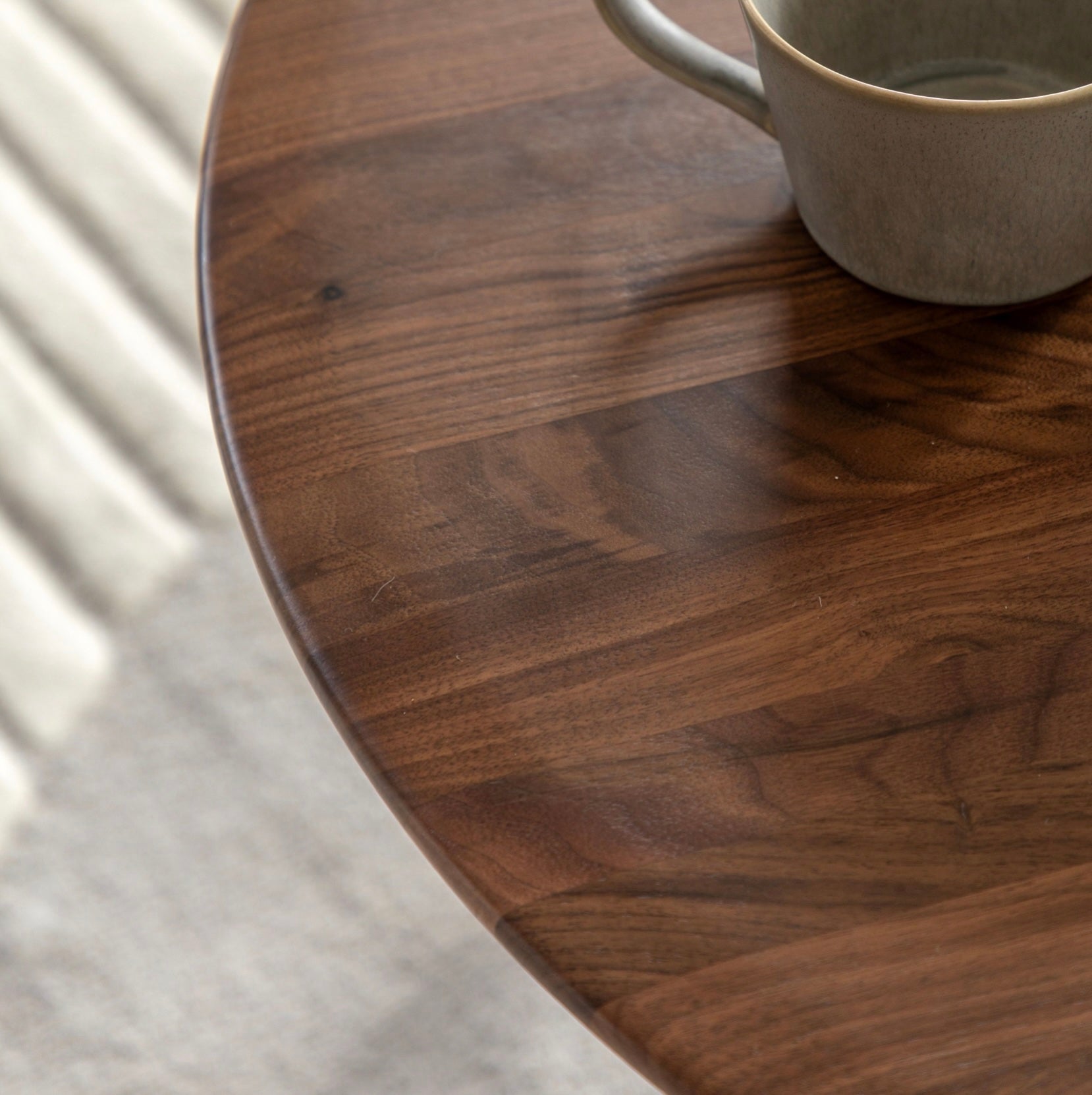 Walnut wooden coffee  table with a cup on a light background