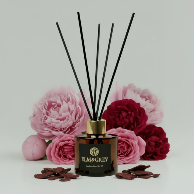 Reed diffuser with floral design and 'Elm & Grey' branding on a light gray background.
