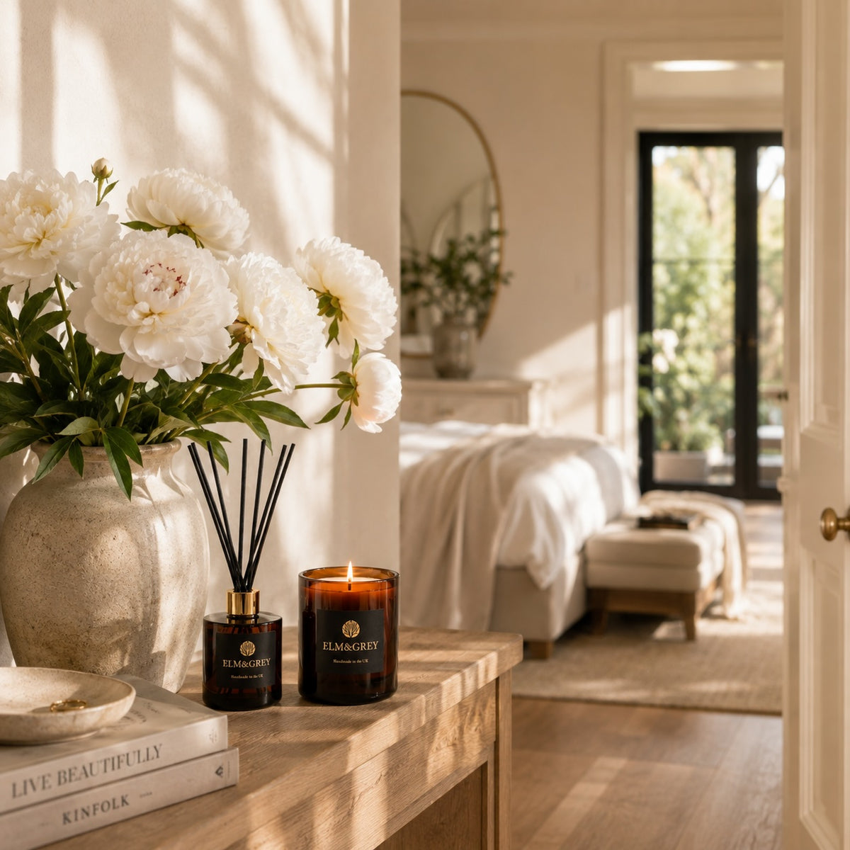 Elm & Grey Velvet Peony & Oud candle and reed diffuser styled in an elegant bedroom and dressing space