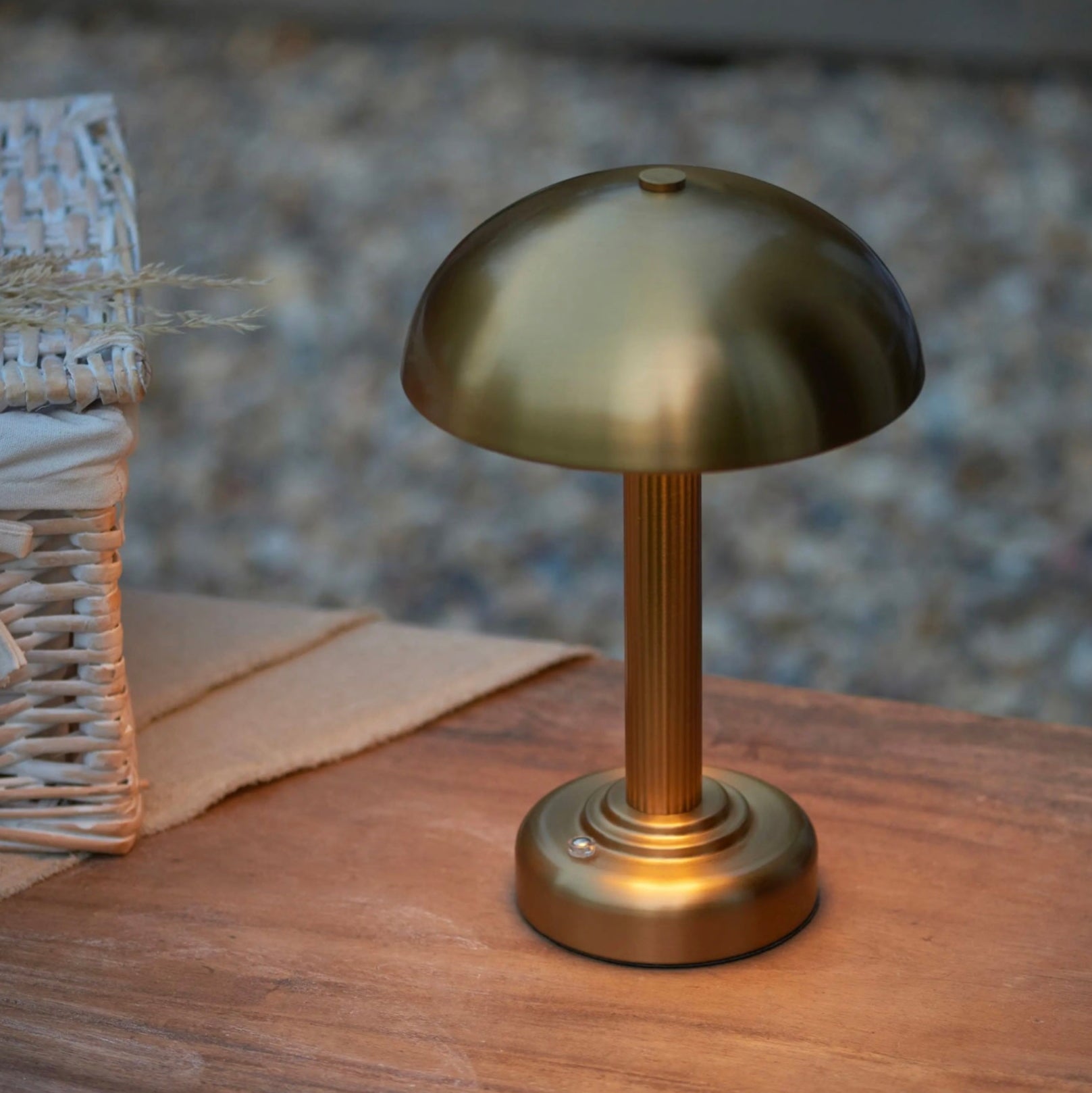Brass table lamp on a wooden surface with a blurred background