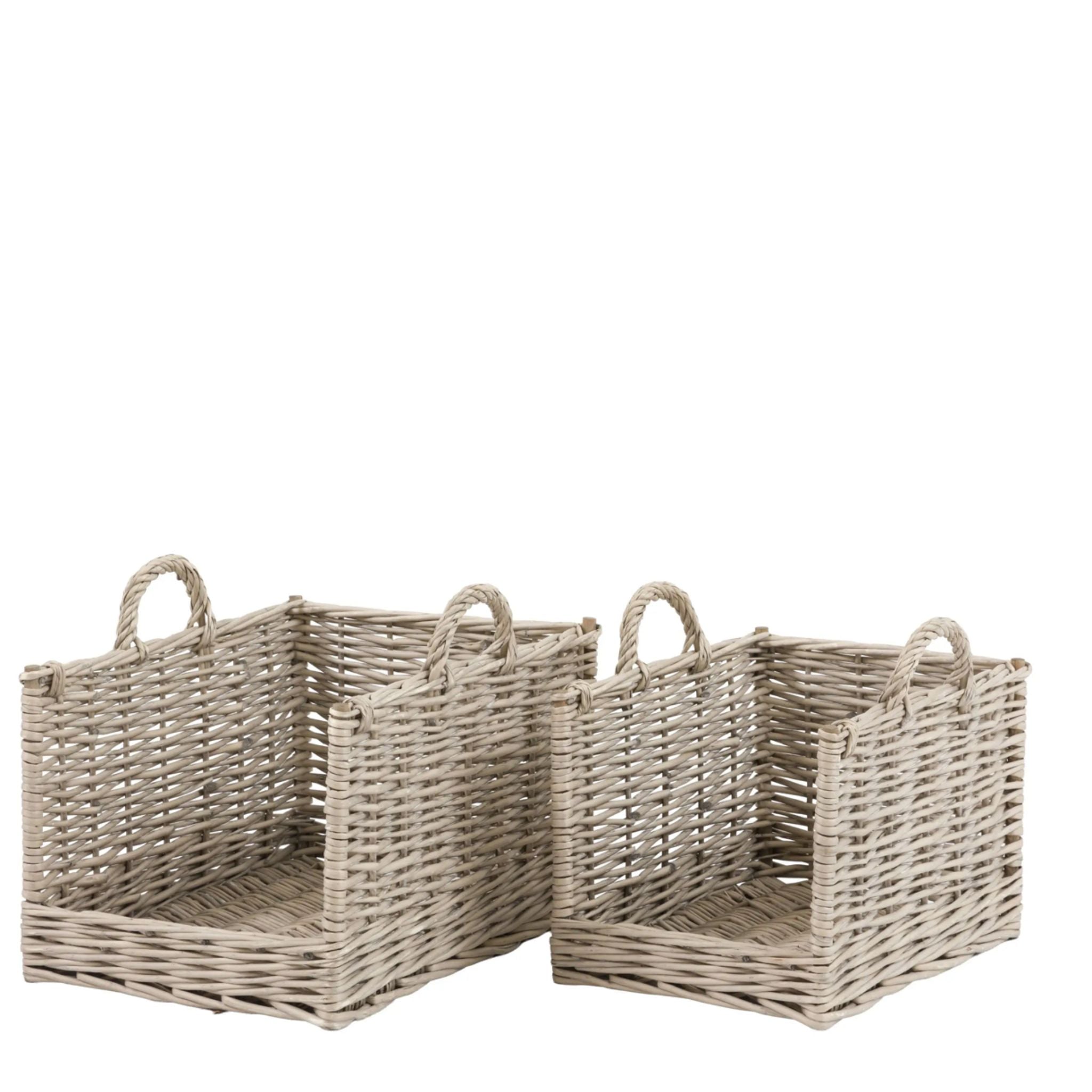 Three wicker baskets with handles on a white background