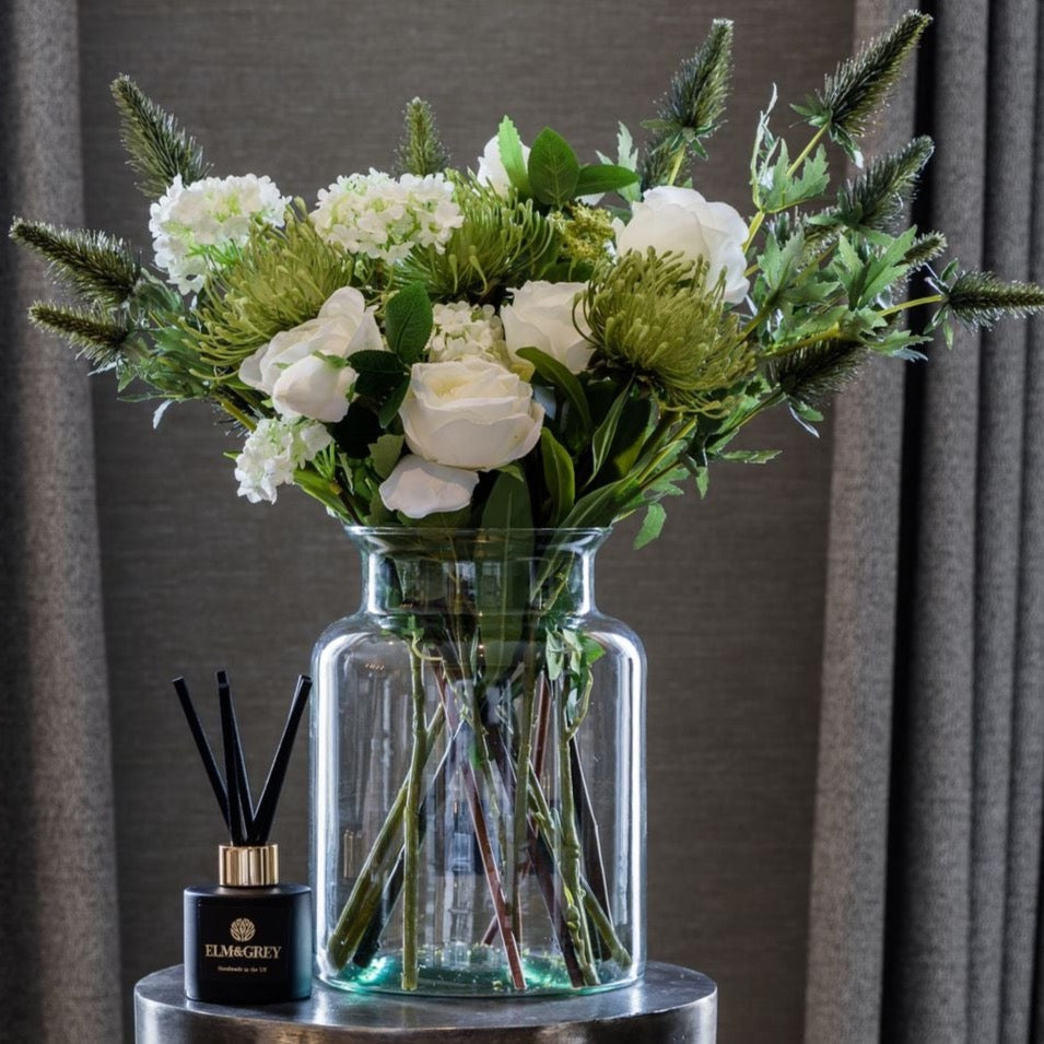 Reed diffuser and bouquet of white and green faux flowers
